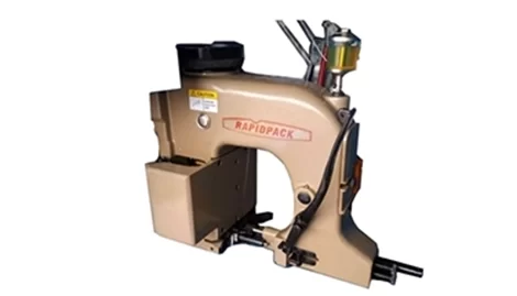 Streamlined Rapidpack stitching machine at port facility, equipped with dual‑thread chain stitch head and safety guards