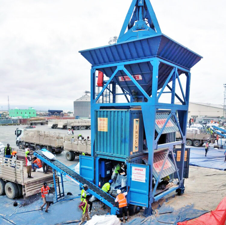 Blue Rapidpack truck loading conveyor with a hydraulic-height adjustable telescopic frame, anti-slip chevron-pattern belt, mounted on heavy-duty wheels, set up outdoors beside a loading area.